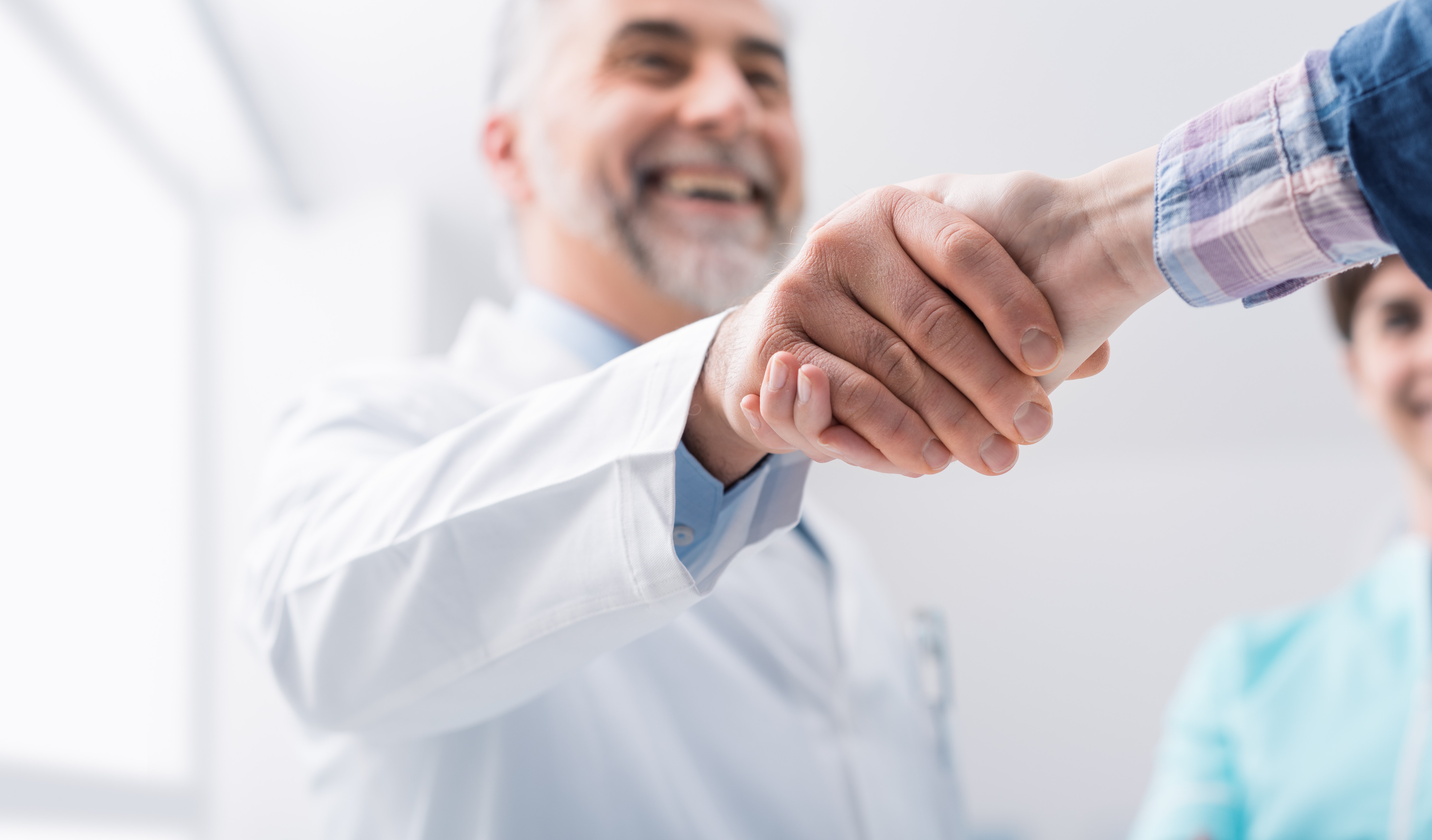 Two men shaking hands in a business greeting.