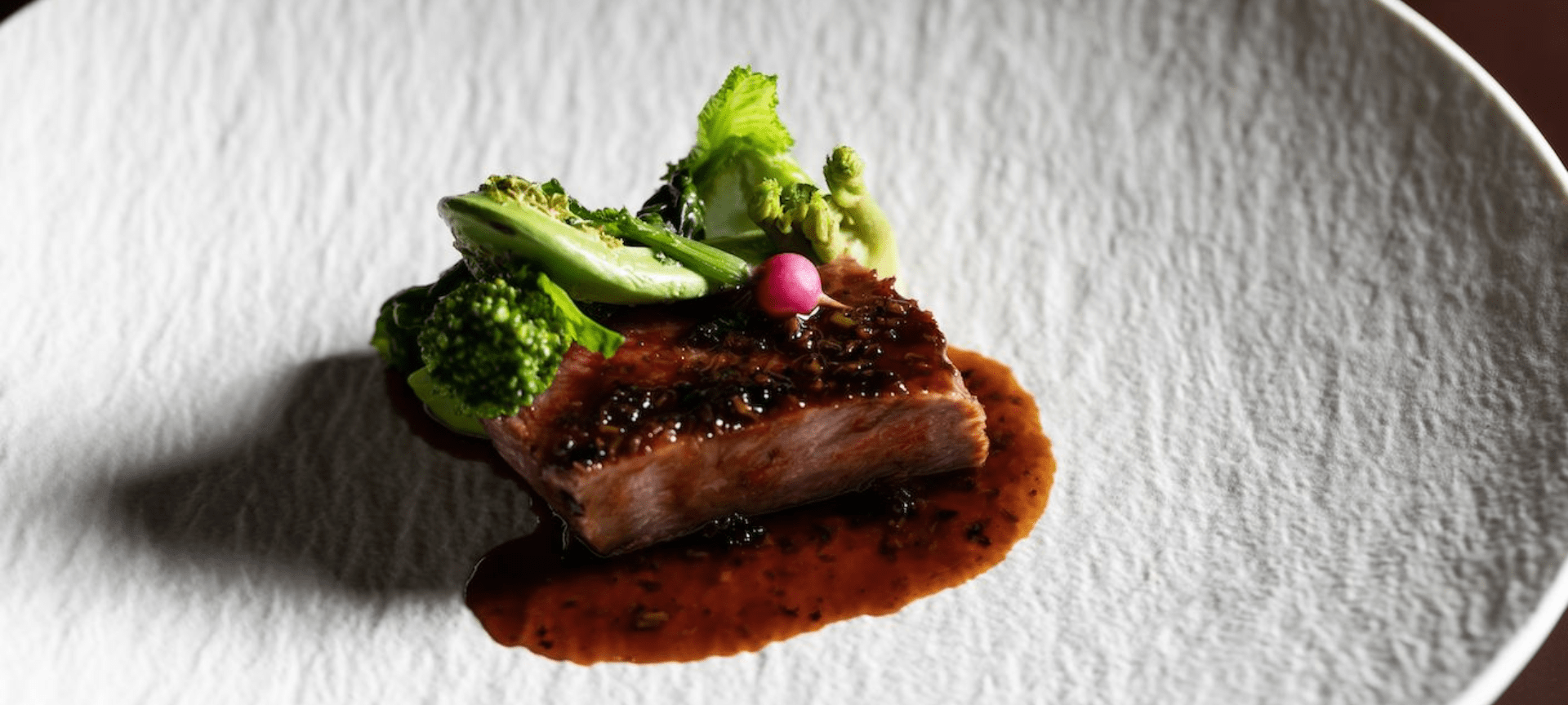 Image of a beautifully presented dish with lamb meat and broccoli.