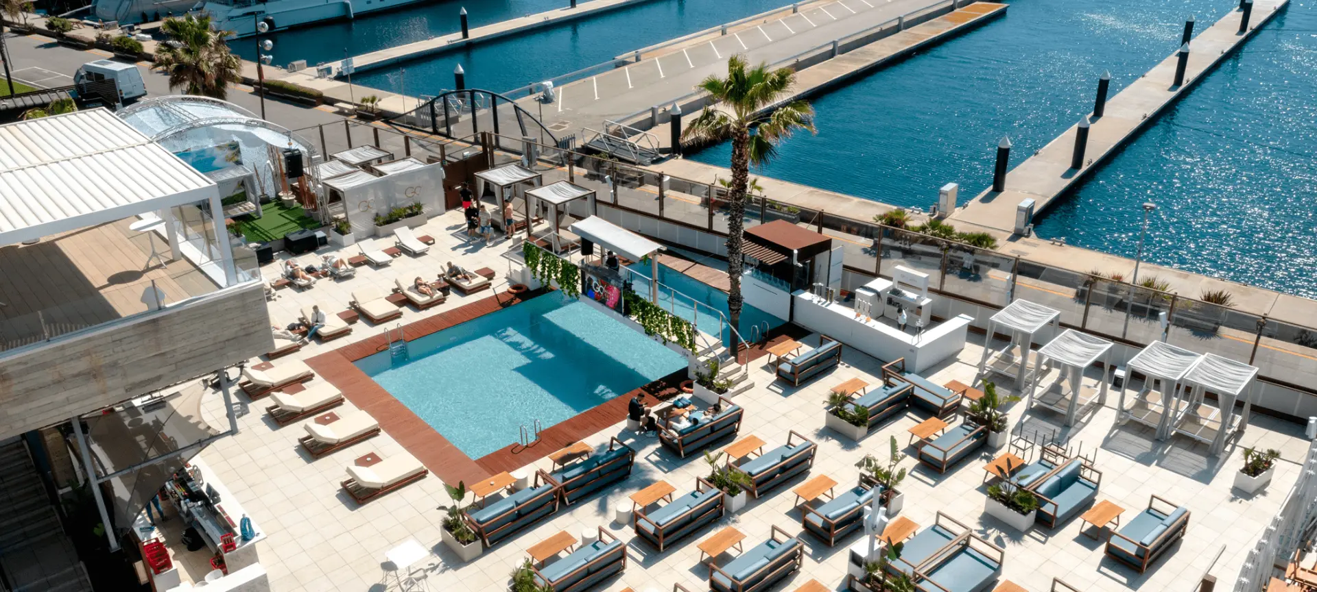 Aerial view of Go Beach Club, where the pool, loungers, and sea come together to create a unique coastal space to unwind and enjoy the surroundings.