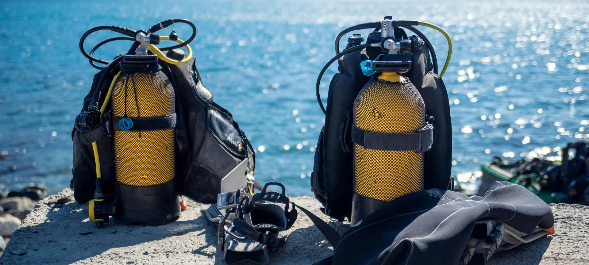 Two scuba diving sets ready to go, overlooking the sea in Catalonia