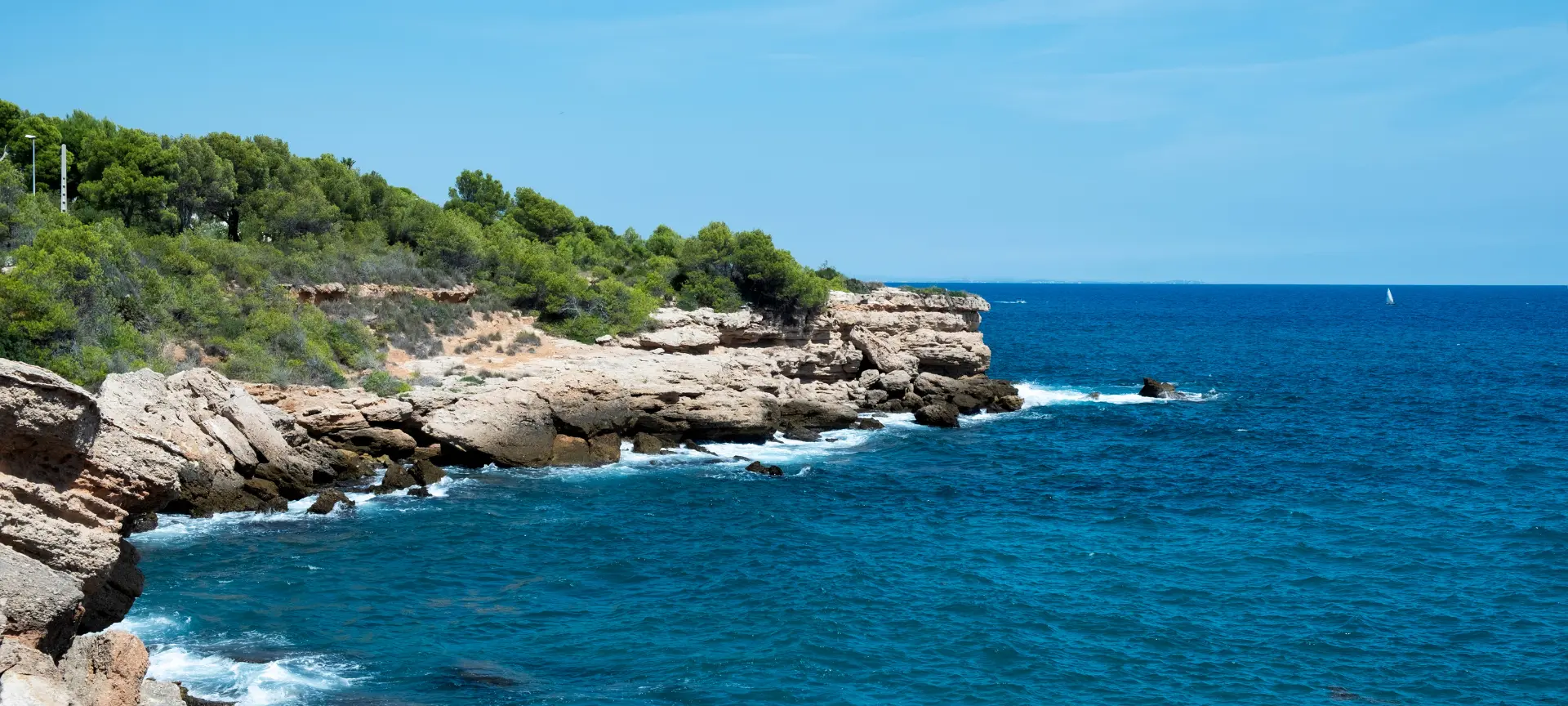 Aerial view of L&rsquo;Ametlla de Mar, with its crystal-clear waters and lush natural setting, perfect for diving.
